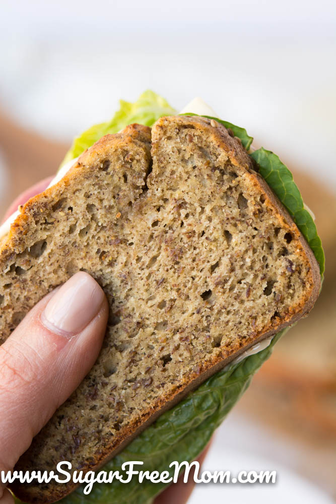 close up view of a hand holding a sandwich