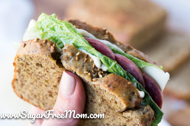 close up view of a hand holding a sandwich